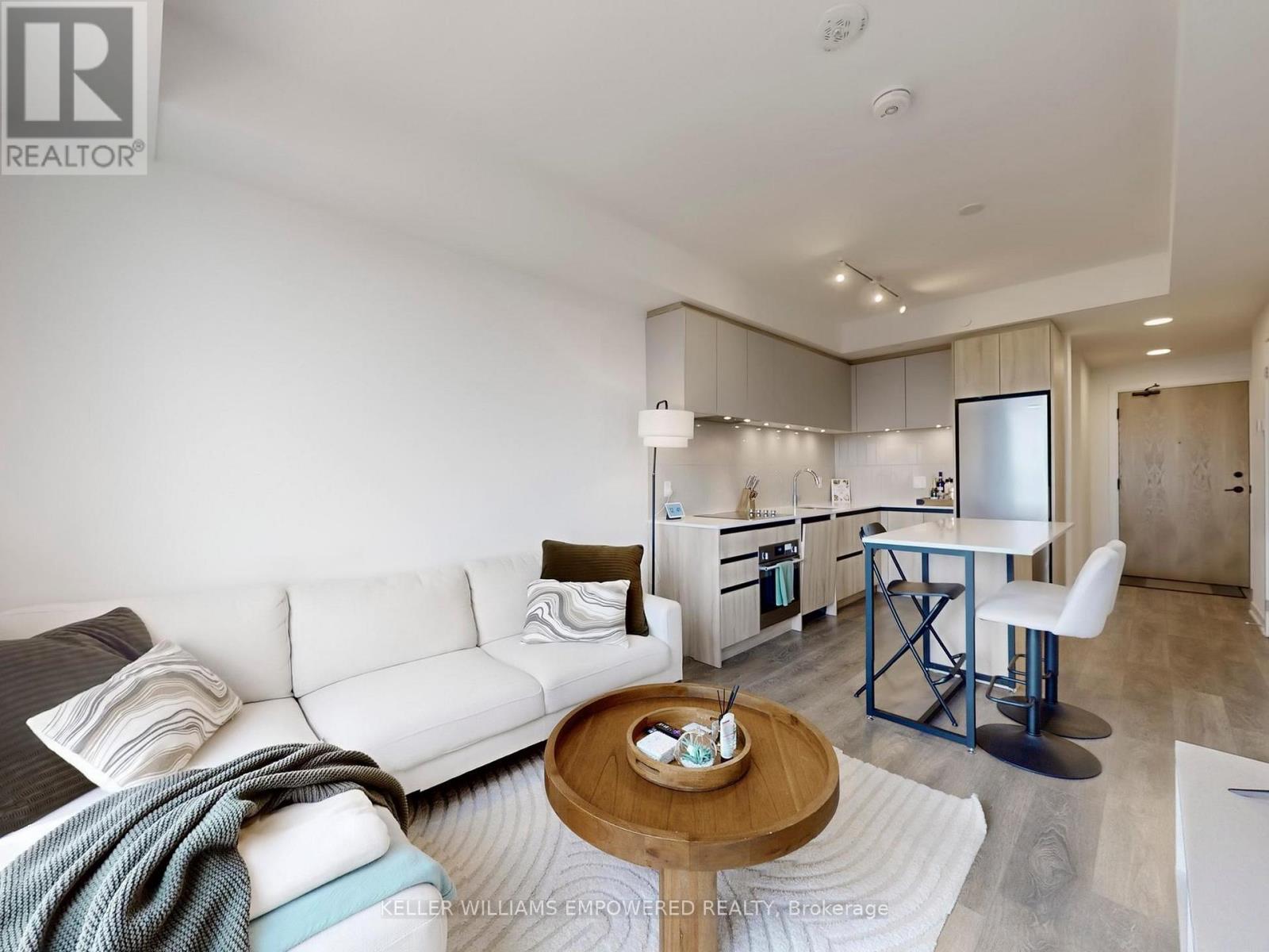 A modern living room with a white sofa and a coffee table.