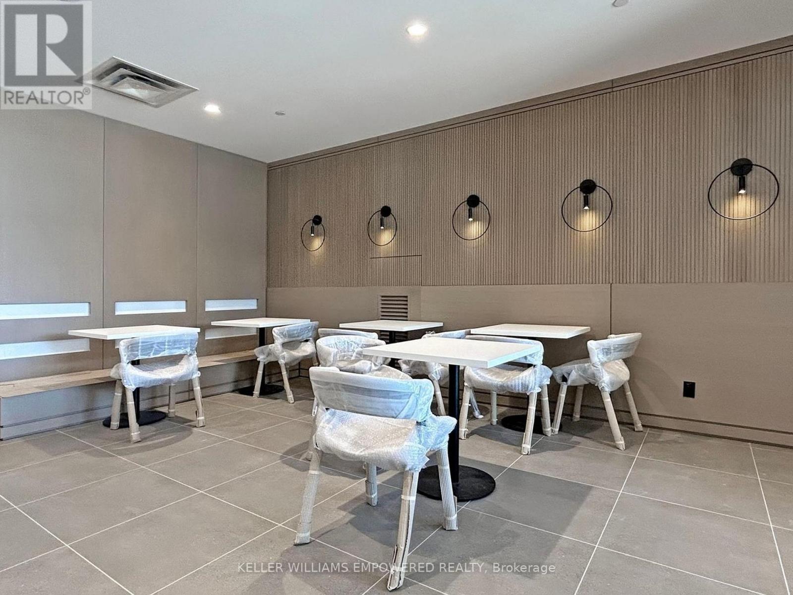 A dining room with a table and chairs.