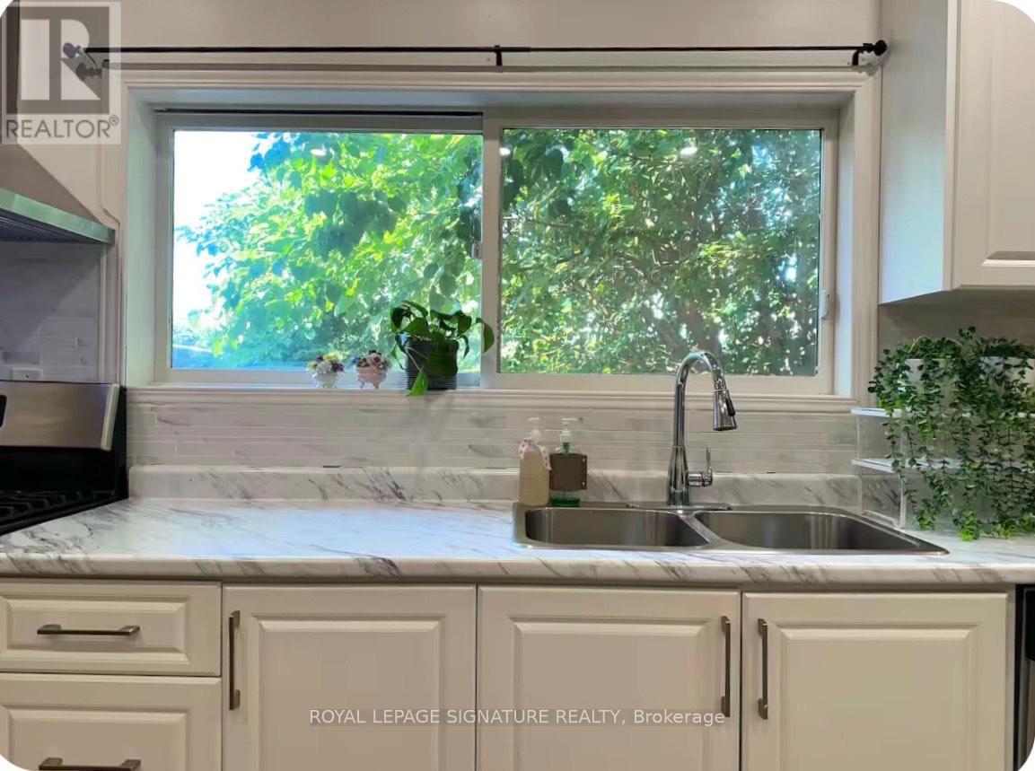 A kitchen with a sink and a window.