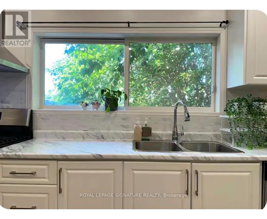 A kitchen with a sink and a window.