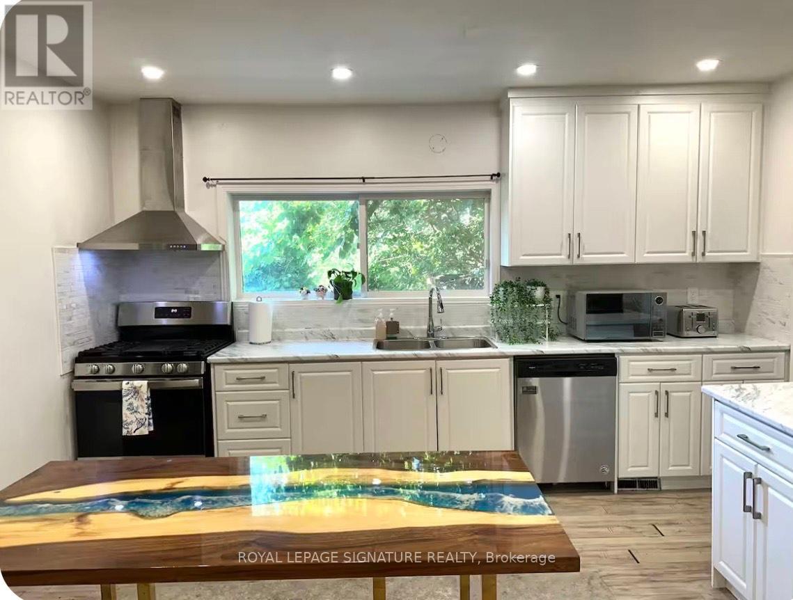 A kitchen with a wooden table in front of it.