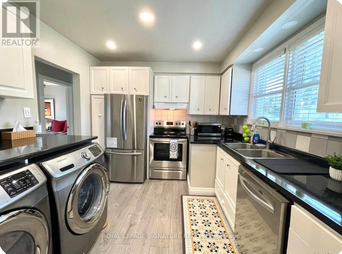 A well-equipped kitchen with a washer and dryer.