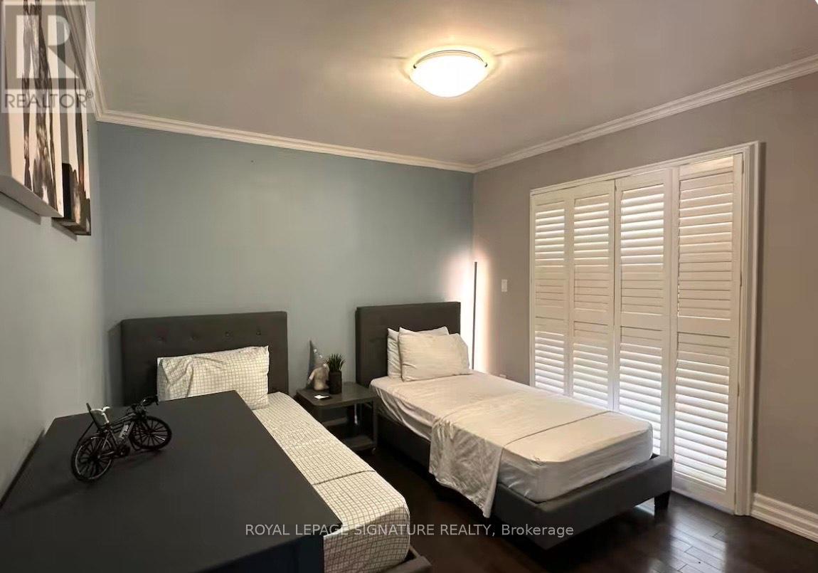 A bedroom with two beds and a bicycle on the bedspread.