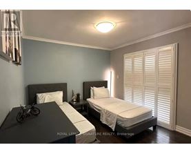 A bedroom with two beds and a bicycle on the bedspread.
