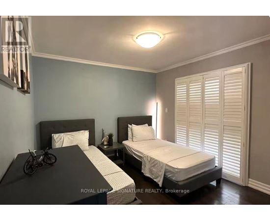 A bedroom with two beds and a bicycle on the bedspread.