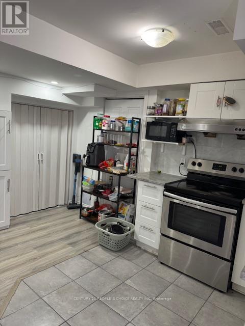 A kitchen with a stove top oven and a microwave.