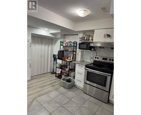A kitchen with a stove top oven and a microwave.