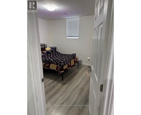 A bedroom with a bed and a window.