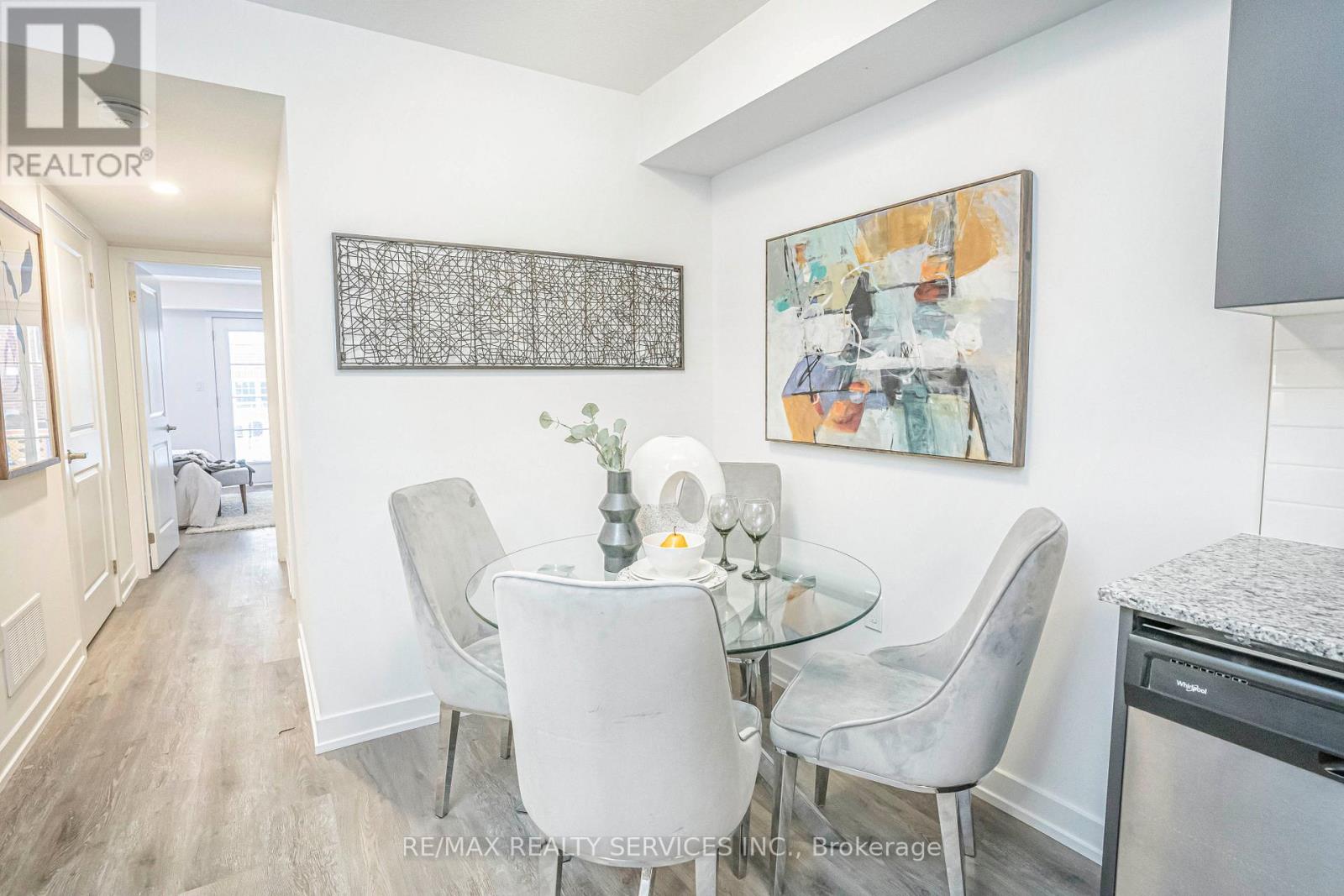 A dining room with a glass table and chairs.