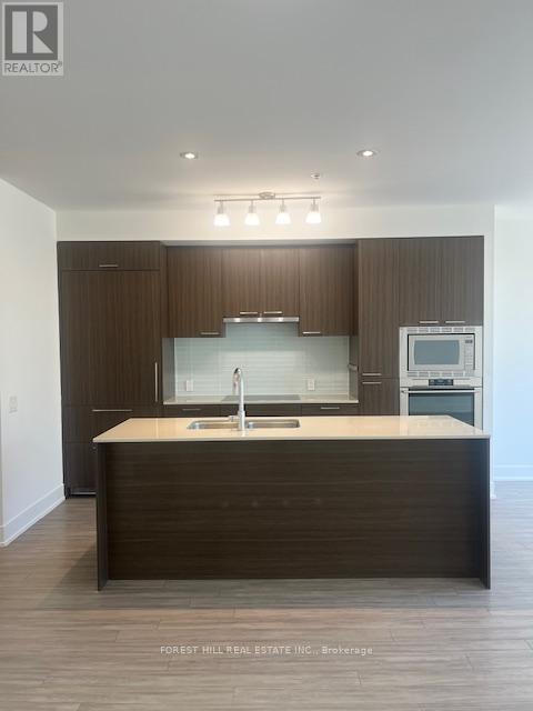 A modern kitchen with a sink and a refrigerator.
