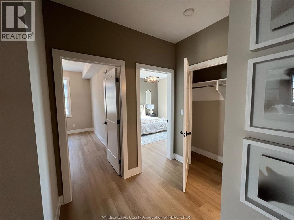 A well-lit, spacious room with a bed and a wooden floor.