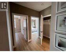 A well-lit, spacious room with a bed and a wooden floor.