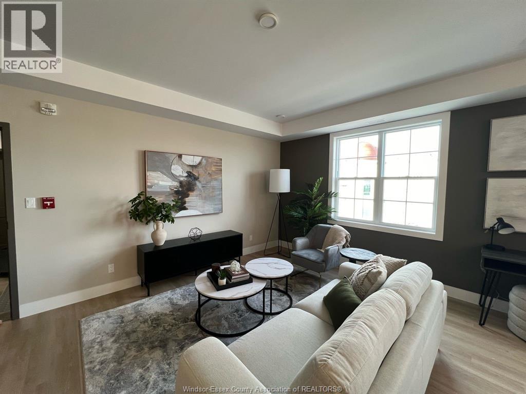 A living room with a couch, coffee table, and a painting on the wall.