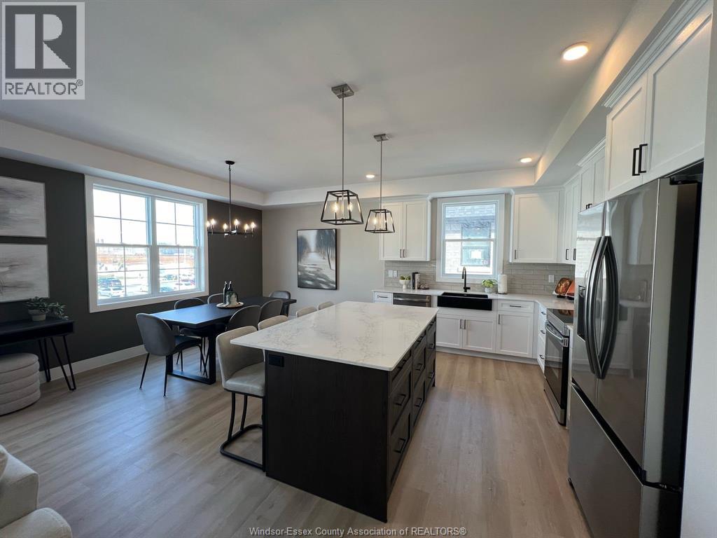 A kitchen with a refrigerator on the right side.