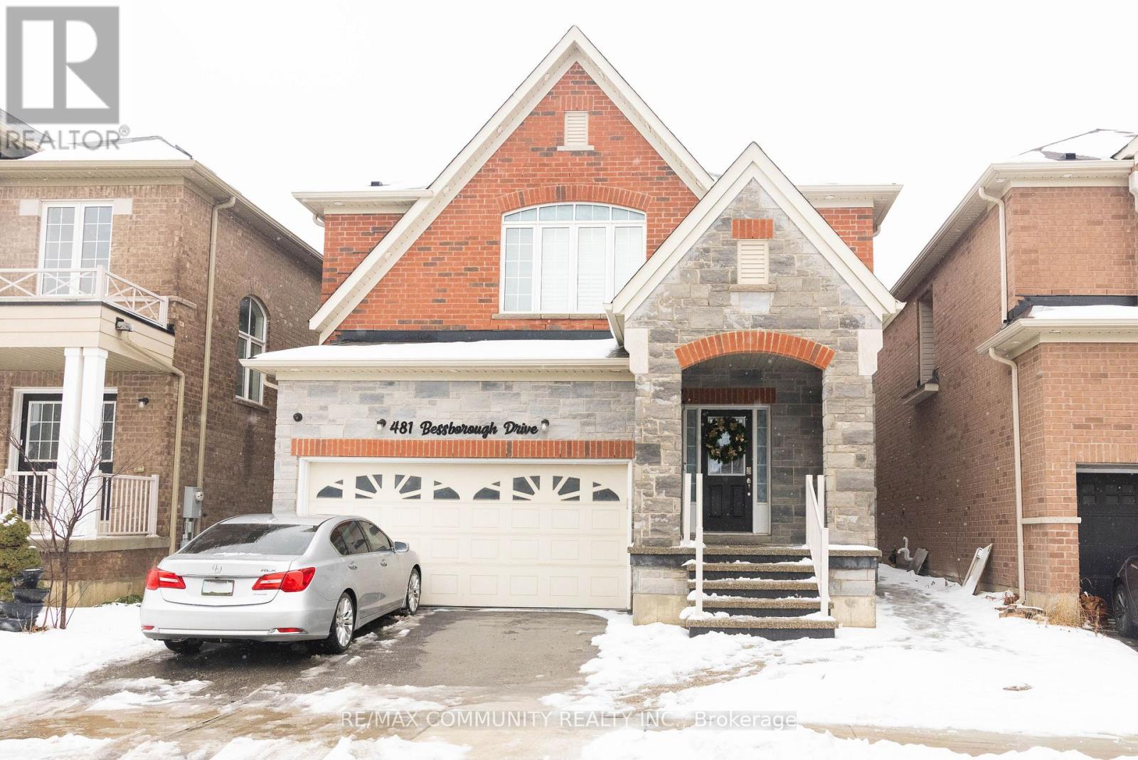 A house with a car parked in front of it.