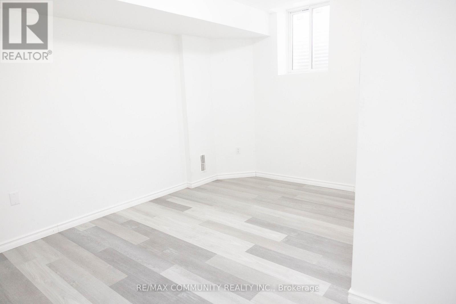 A room with a wooden floor and white walls.