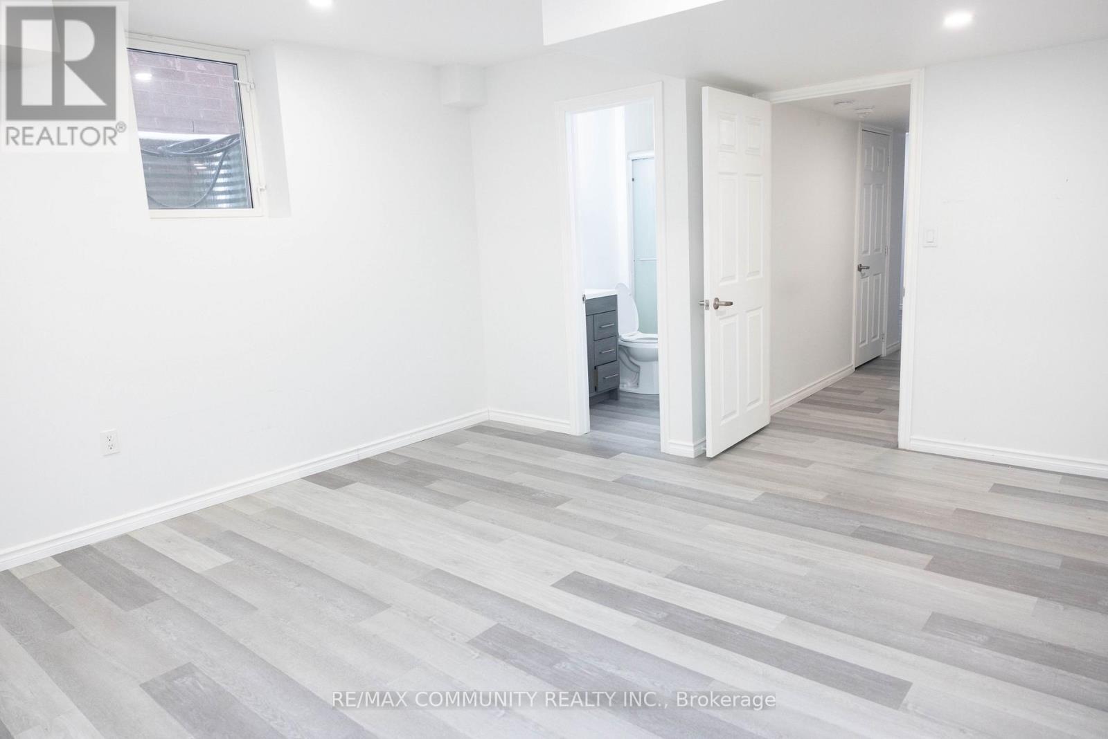 A room with a grey floor and white walls.