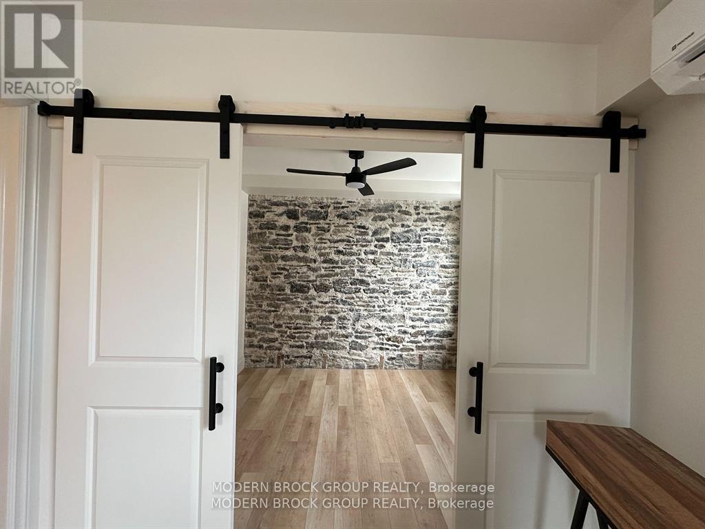 A room with a sliding door and a ceiling fan.