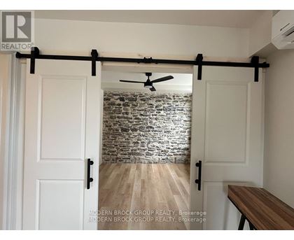 A room with a sliding door and a ceiling fan.