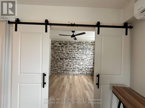 A room with a sliding door and a ceiling fan.