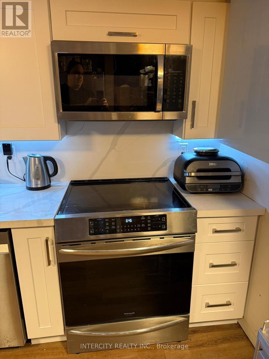 A kitchen with a stove top oven and microwave.
