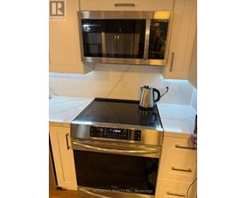 A kitchen with a stove top oven and microwave.