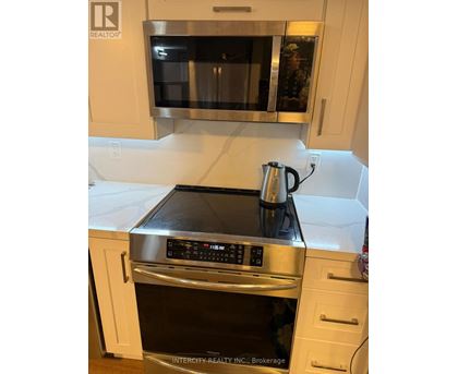 A kitchen with a stove top oven and microwave.