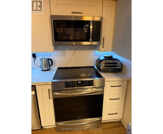 A kitchen with a stove top oven and microwave.