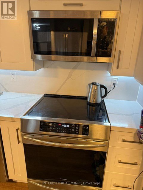 A kitchen with a stove top oven and microwave.