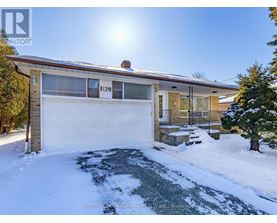 A house numbered 11291 is shown with snow on the ground and a sunny sky.