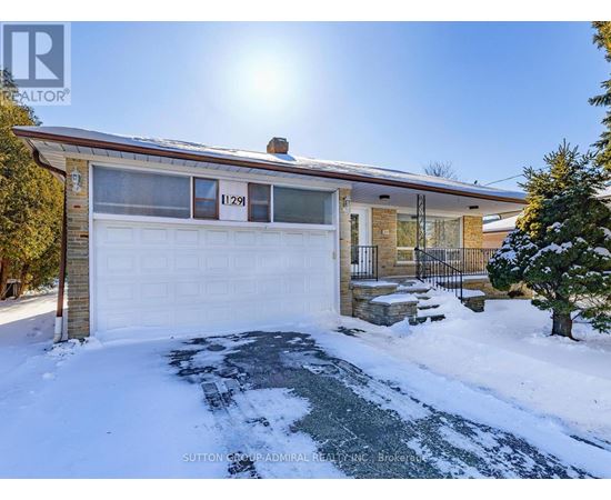 A house numbered 11291 is shown with snow on the ground and a sunny sky.