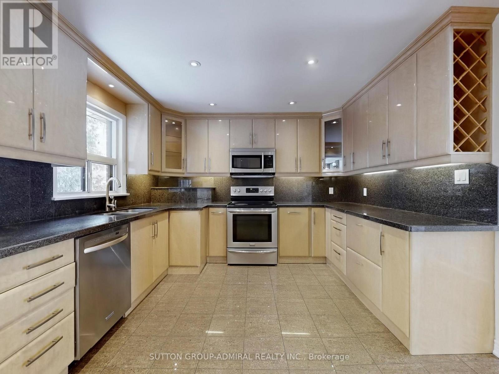 A kitchen with wooden cabinets and granite countertops.