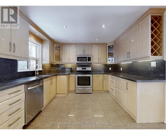 A kitchen with wooden cabinets and granite countertops.