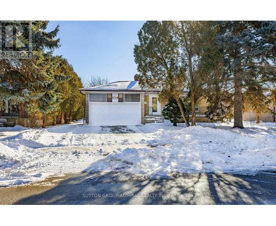A house with a white garage door is surrounded by snow.