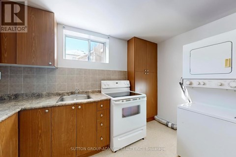 A kitchen with wooden cabinets and a white stove top oven.