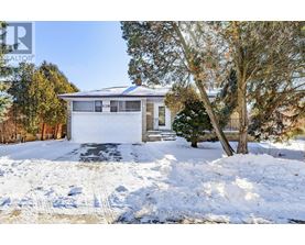 A house with a garage and a driveway covered in snow.