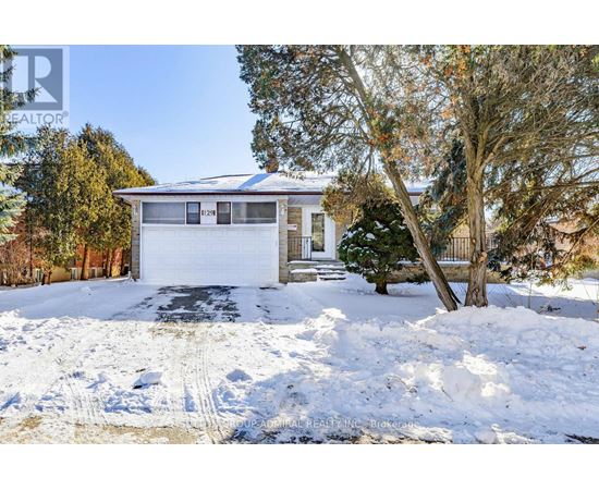 A house with a garage and a driveway covered in snow.
