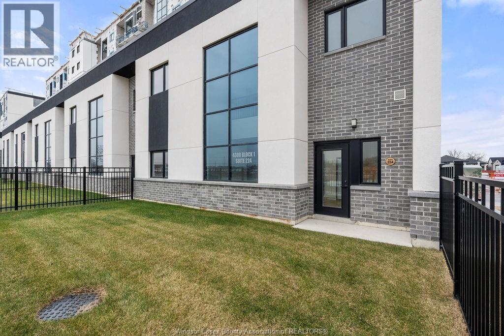 A modern building with a black gate and a sign that says REALTOR.