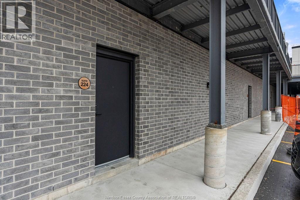 A brick building with a black door and a sign that says REALTOR.