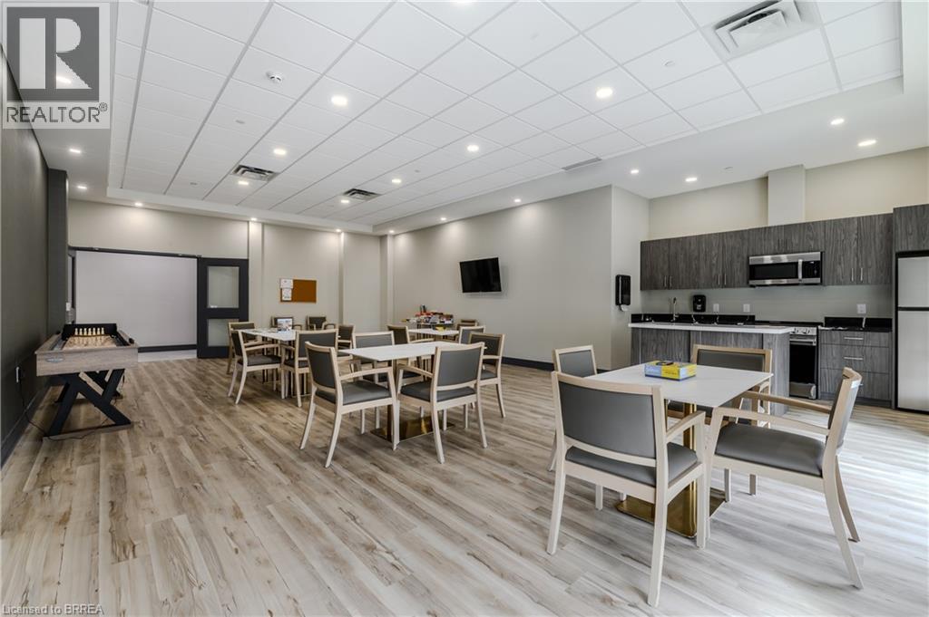 A dining room with a wooden floor and white walls.