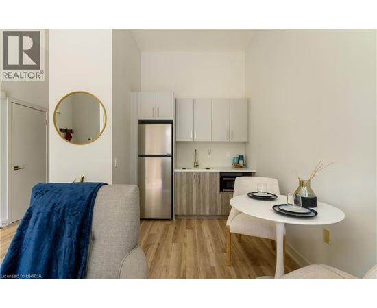 A modern kitchen with a dining table and chairs.