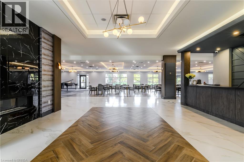 A spacious office lobby with a wooden floor and a reception desk.