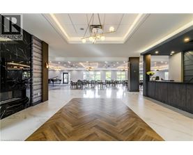 A spacious office lobby with a wooden floor and a reception desk.