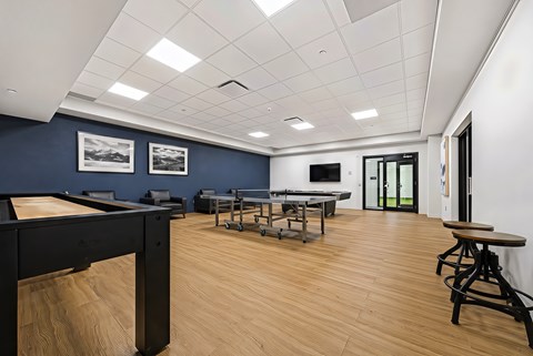 A room with a pool table and a bar.