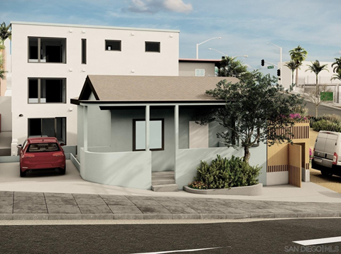 A modern house with a red car parked in front.