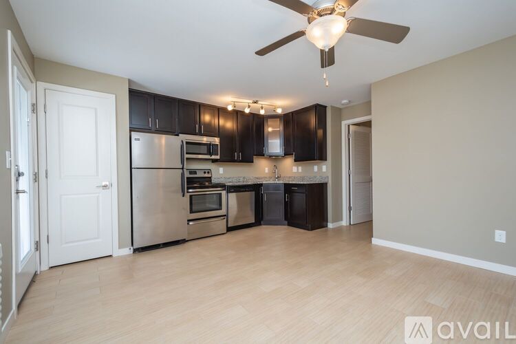 A kitchen with a refrigerator, oven, microwave, and dishwasher.