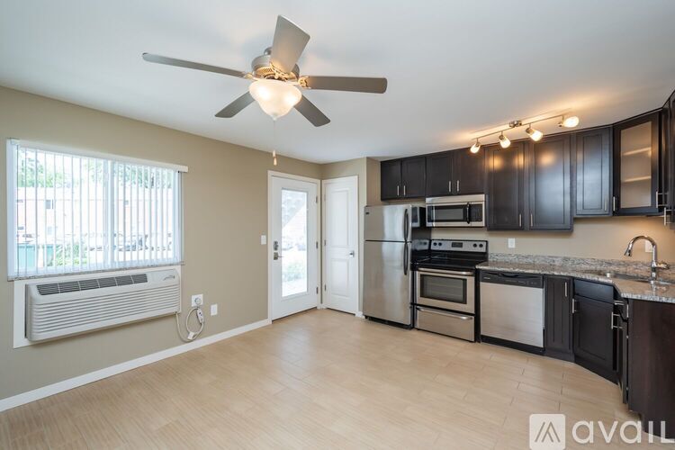 A kitchen with a fan and a window.