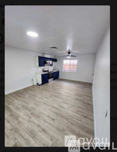 A room with a ceiling fan and light fixture.