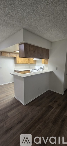 A kitchen with white cabinets and a wooden island.