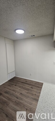 A room with a wooden floor and white walls.